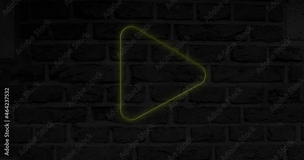 Animation of glowing neon play button icon on brick wall Animation of glowing neon play button icon on brick wall