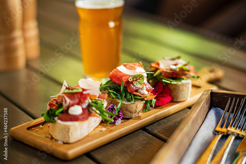 Glass of cold beer with delicious tapas