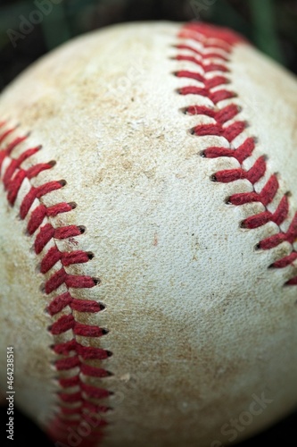 Baseball strings on a ball on grass background