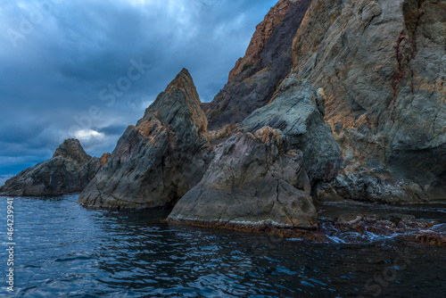 rocks of Cape Fiolent against the background of the evening sky with clouds