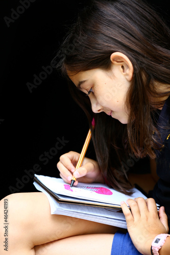 girl drawing as home work