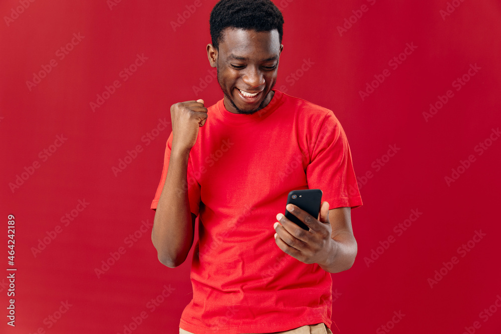 Cropped view of cheerful african man with phone in hands Cropped view of cheerful african man with phone in hands