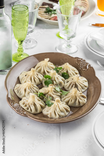 Georgian dumplings Khinkali with meat on brown plate on the table