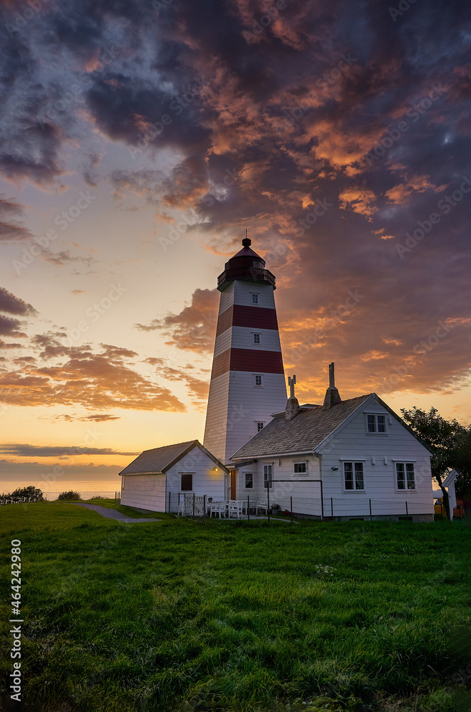 Colorful setting sun over Alnes lighthouse, Godøy, Norway Colorful setting sun over Alnes lighthouse, Godøy, Norway