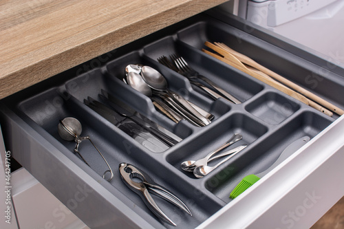 Drawer with cutlery in kitchen photo