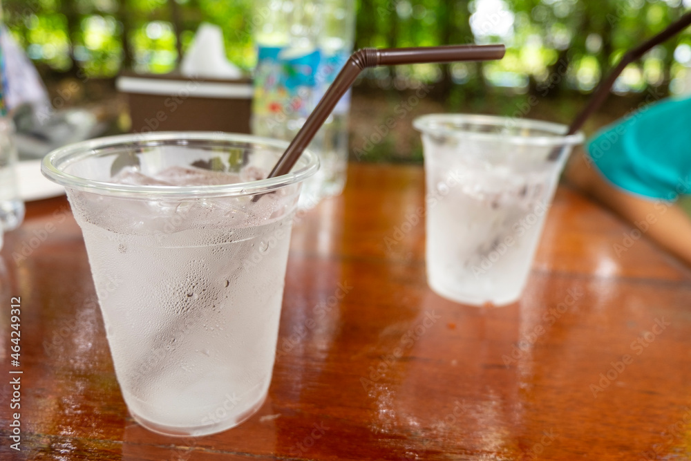 A clear plastic tumbler full of water and ice. A clear plastic tumbler full of water and ice.