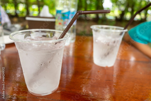 A clear plastic tumbler full of water and ice.
