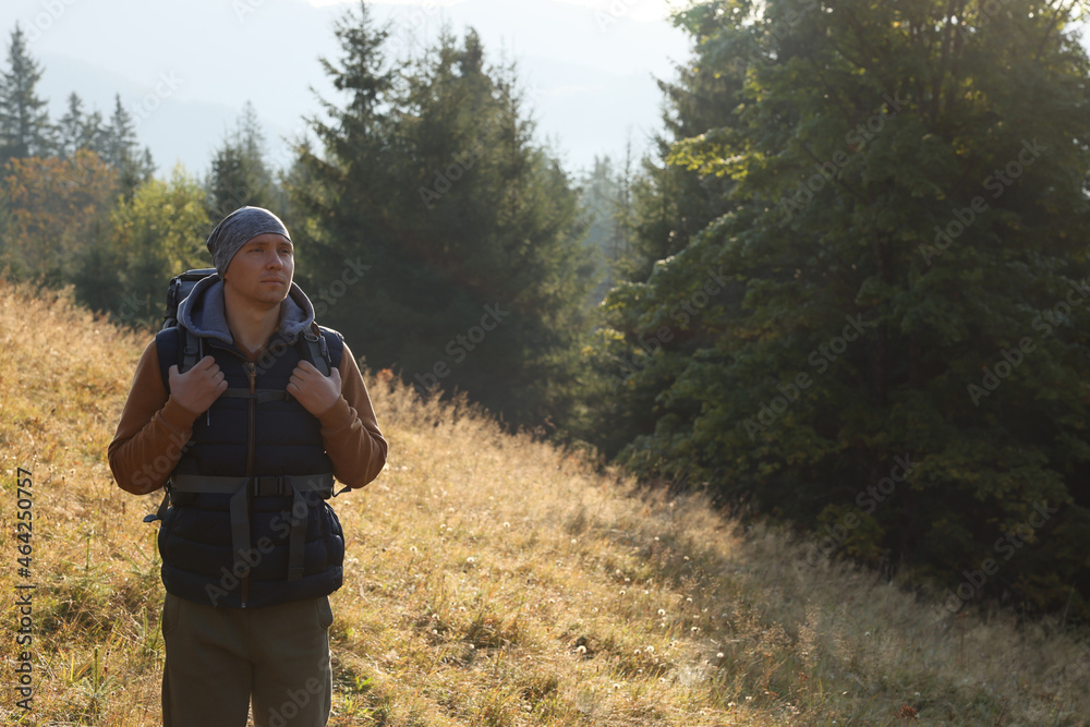 Tourist with backpack in nature on sunny day. Space for text Tourist with backpack in nature on sunny day. Space for text