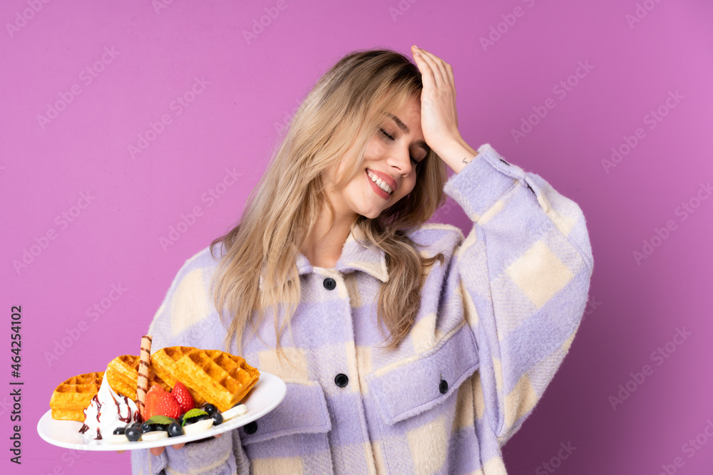 Teenager Russian girl holding waffles isolated on purple background has realized something and intending the solution Teenager Russian girl holding waffles isolated on purple background has realized something and intending the solution