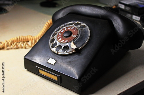 very old black phone with dial