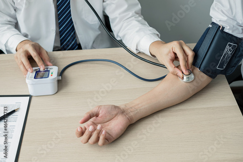 Man doctors measured blood pressure, the patient examined the heartbeat, and talked about health care closely. Medical and health care concepts