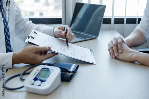 Man doctors explain and recommend treatment after a female patient meets a doctor and receives results regarding illness problems. Medical and health care concepts photo