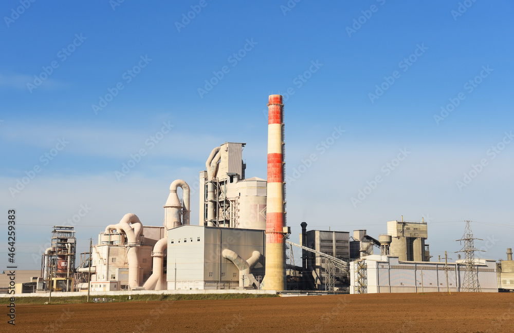 Cement plant with pipes. Сement production process and Industrial solution. factory with smoke pipe. Chimney smokestack emission. Poor environment. Ecology concept, air and environmental pollution.