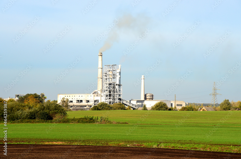 Refinery plant with pipes. Smoke tower of industrial factory CHP. Chimney smokestack emission. Plant with smoke frow pipe and environmental pollution. Ecology concept and poor environment.