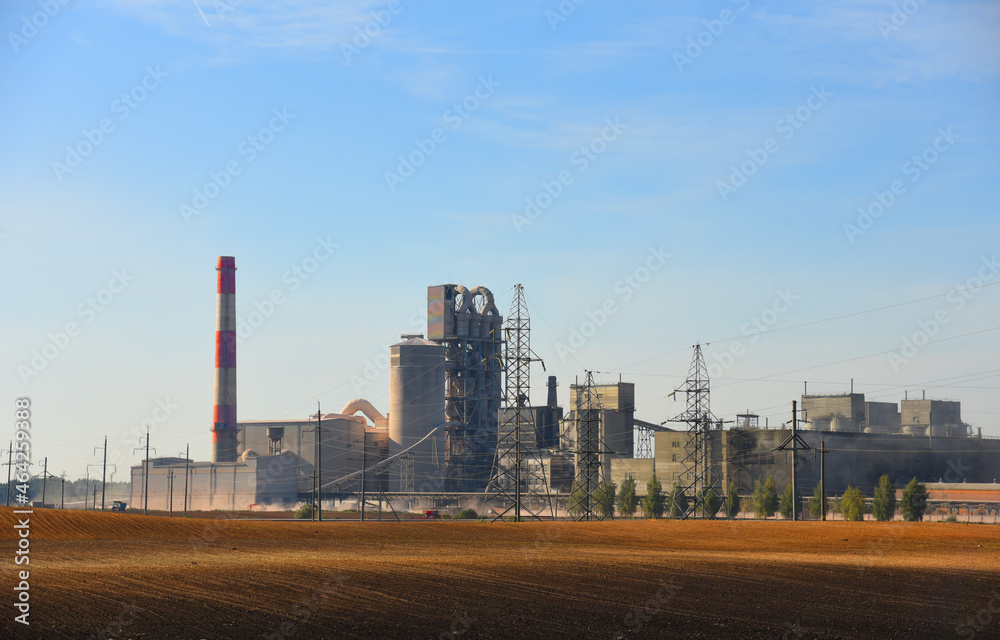 Cement plant with pipes. Сement production process and Industrial solution. factory with smoke pipe. Chimney smokestack emission. Poor environment. Ecology concept, air and environmental pollution.