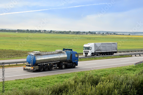 Isothermal Tank truck driving on highway. Oil and Gas Transportation and Logistics. Metal chrome cistern tanker with petrochemicals. Liquid Chemical Freight and foodstuff.