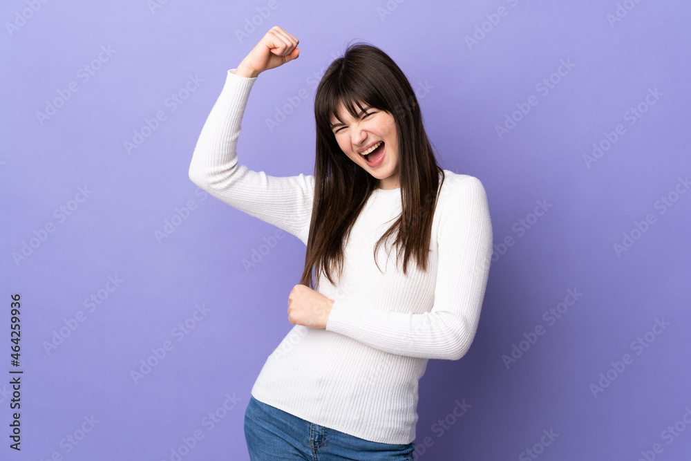 Young Ukrainian woman isolated on purple background celebrating a victory Young Ukrainian woman isolated on purple background celebrating a victory