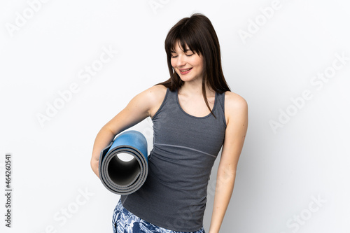 Ukrainian sport girl with mat isolated on blue background with happy expression