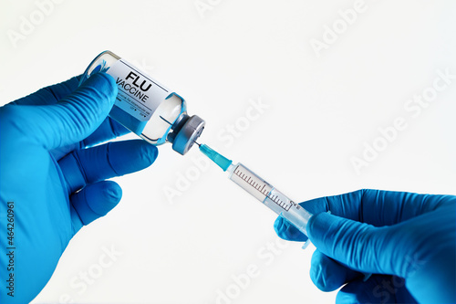 Doctor with syringe and vial of the dose vaccine for Flu or Pneumonia virus. Medicine and health care concept. vaccination for booster shot for Flu virus in the risk population diseases