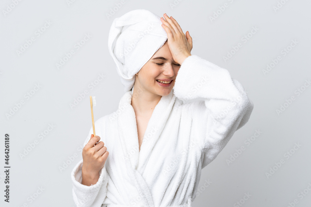 Young woman in a bathrobe holding toothbrush has realized something and intending the solution Young woman in a bathrobe holding toothbrush has realized something and intending the solution