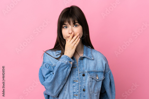 Young Ukrainian woman isolated on pink background surprised and shocked while looking right