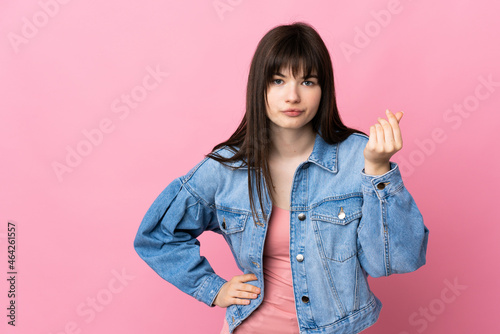 Young Ukrainian woman isolated on pink background making Italian gesture © luismolinero