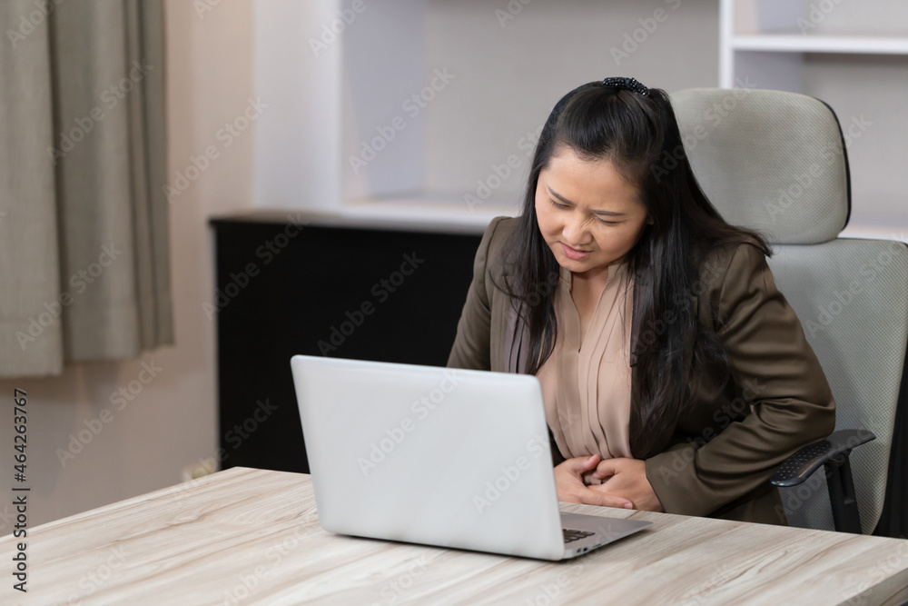 Unhappy woman stomach ache, Business woman with stomach pain feeling unwell sitting in meeting room Unhappy woman stomach ache, Business woman with stomach pain feeling unwell sitting in meeting room
