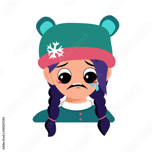 Girl with crying and tears emotion, sad face, depressive eyes and blue hair in bear hat with snowflake. Cute child with melancholy expression in winter headdress. Head of adorable kid with emotions