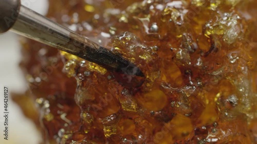 A soldering iron is lowered into rosin