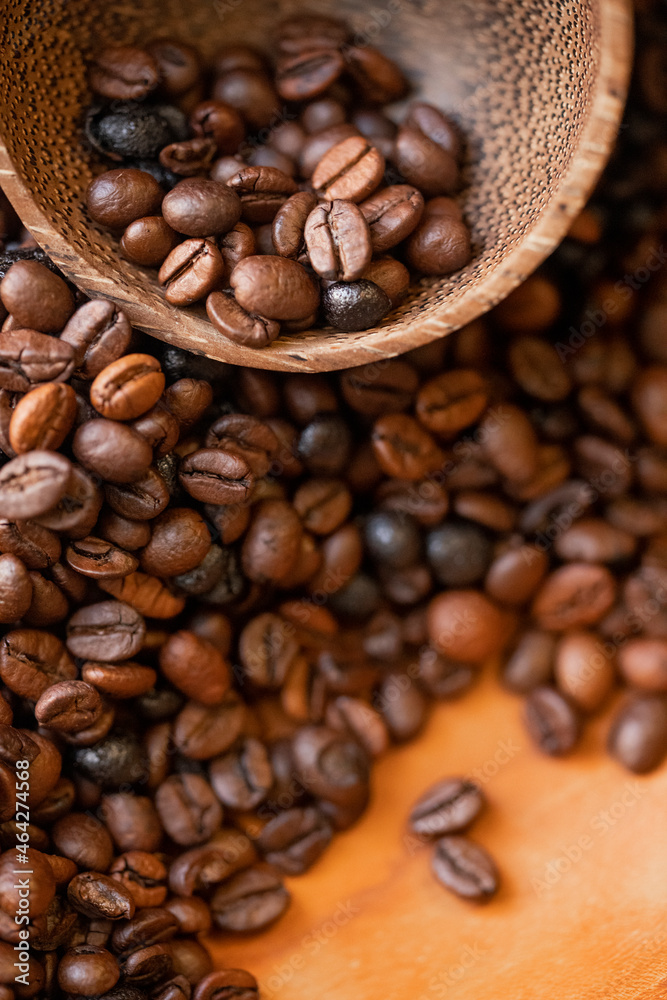 Fototapeta premium Spilled coffee beans and cocoa cup . Macro photography. Close up of coffee beans.