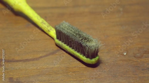 dirty and old used toothbrushes on wooden background