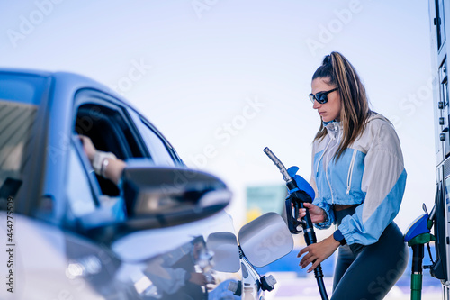 Woman refueling car with anonymous female photo