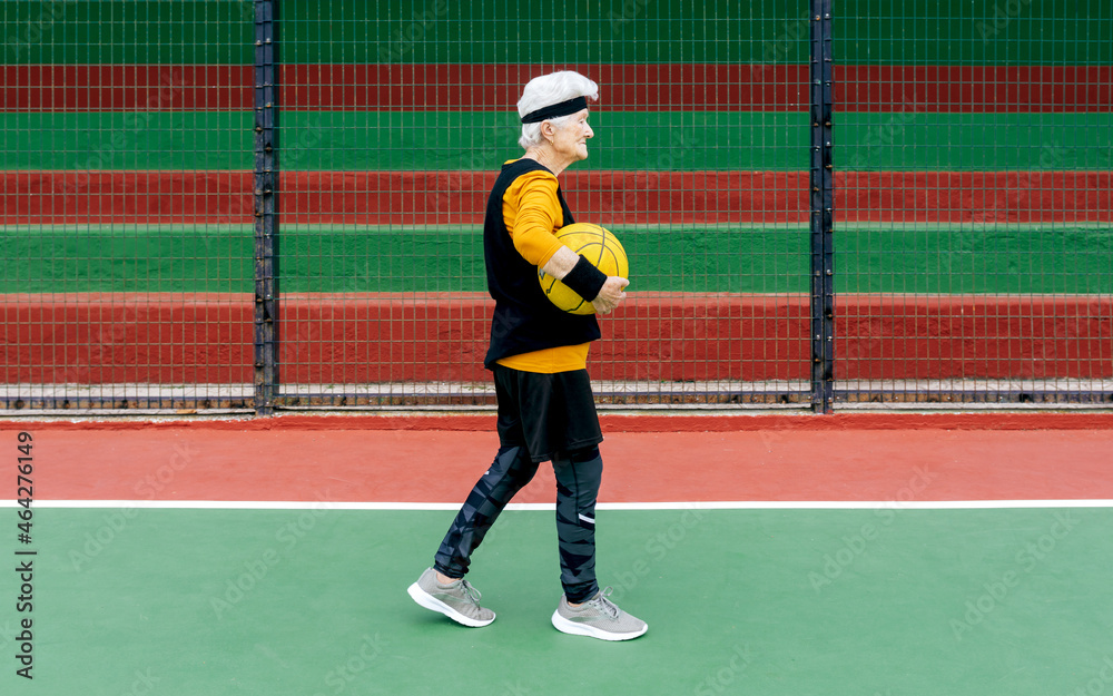 Senior woman with basketball on playground Senior woman with basketball on playground