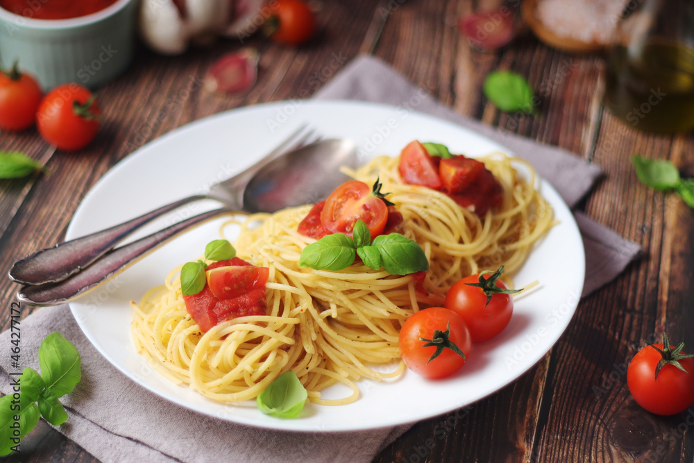 Italian pasta spaghetti with basil and cherry tomatoes Italian pasta spaghetti with basil and cherry tomatoes