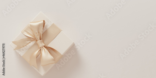 Give gift  holidays are coming concept. Christmas minimal composition. Beige gift box with golden ribbon bow top view  flat lay 3d rendering