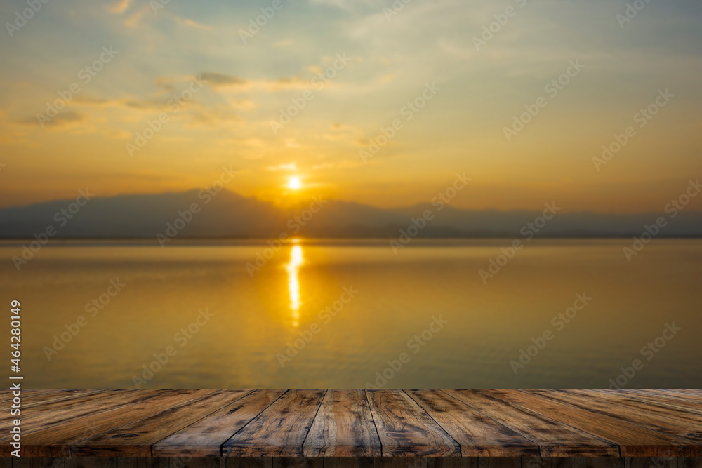 Empty wooden table on beautiful lake sunset.