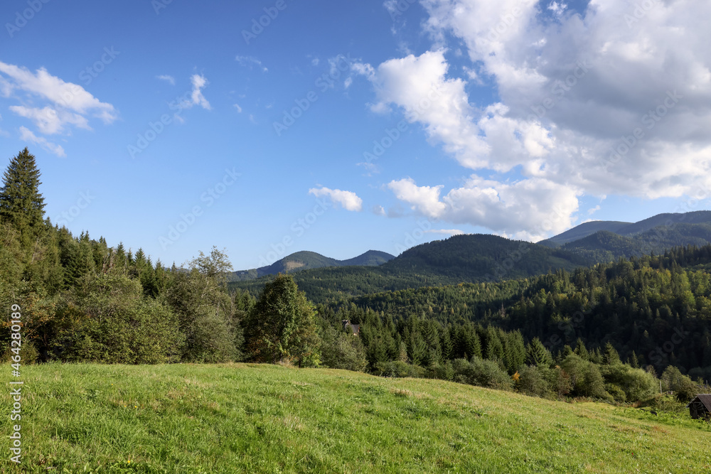Fototapeta premium Beautiful view of blue sky over mountains on sunny day