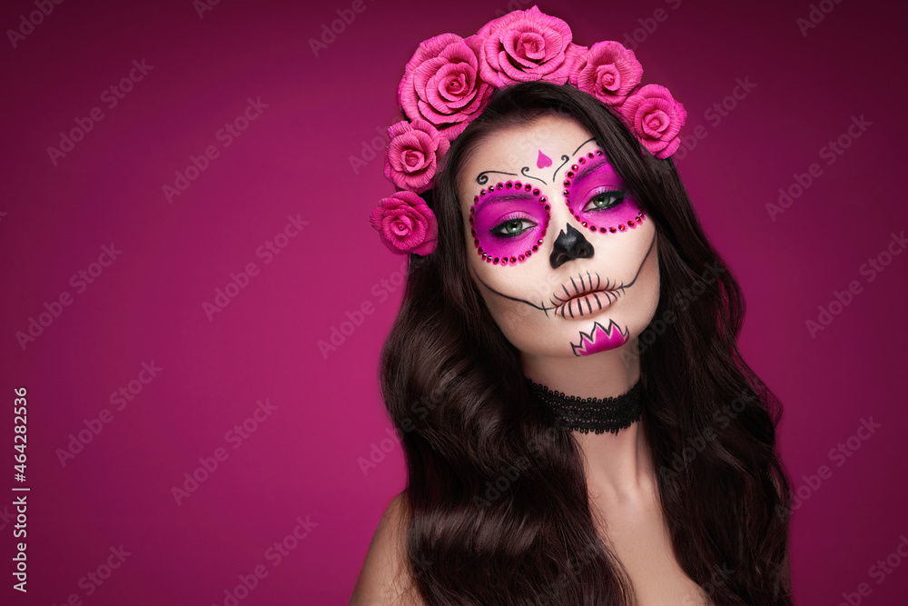 Portrait of a woman with sugar skull makeup over red background. Halloween costume and make-up. Portrait of Calavera Catrina