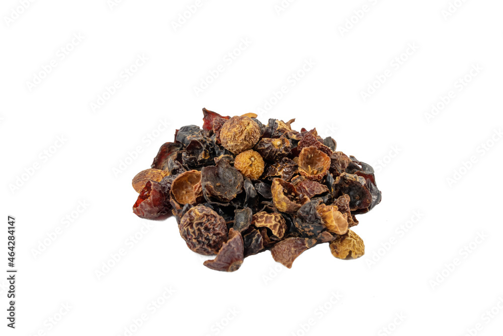 dried rose hip fruit in wooden scoop isolated on white background. Herbs and food ingredients.