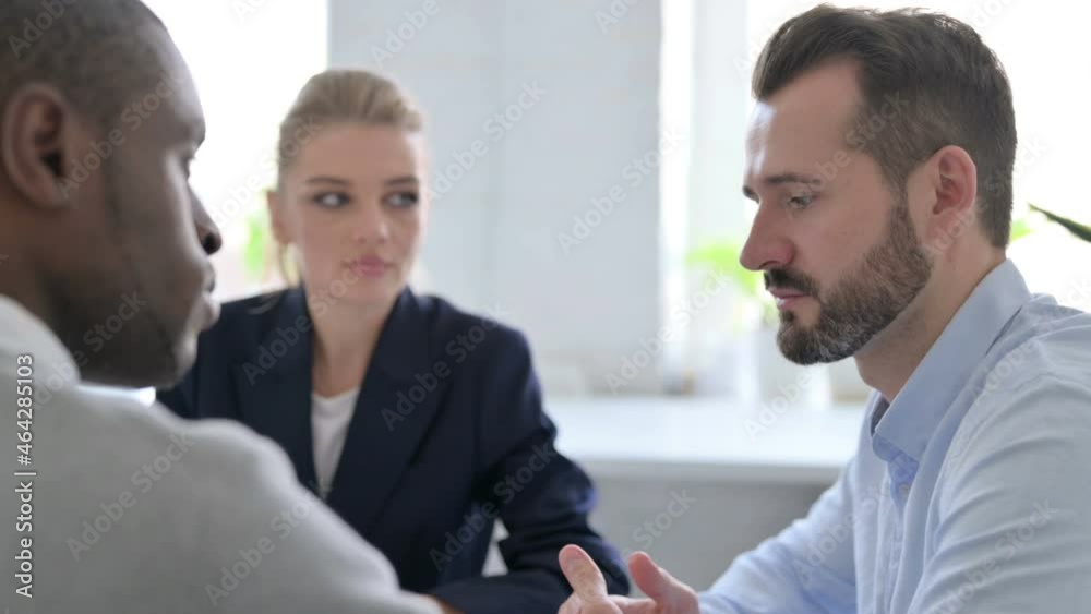 Close up of Businessman Talking to Female and Male Business People Close up of Businessman Talking to Female and Male Business People