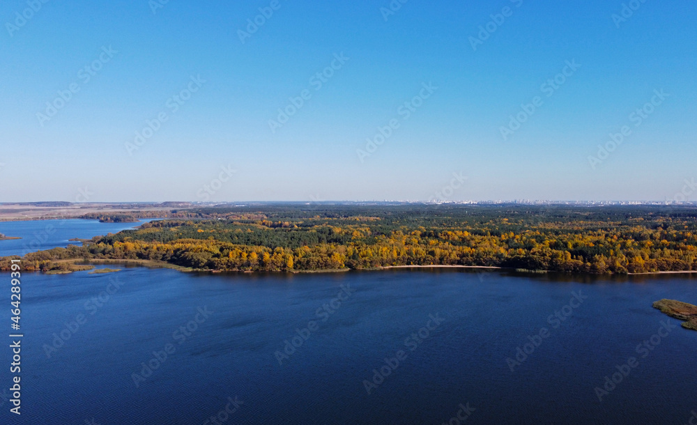 Panoramic aerial view of the forest coast of the sea. Autumn landscape