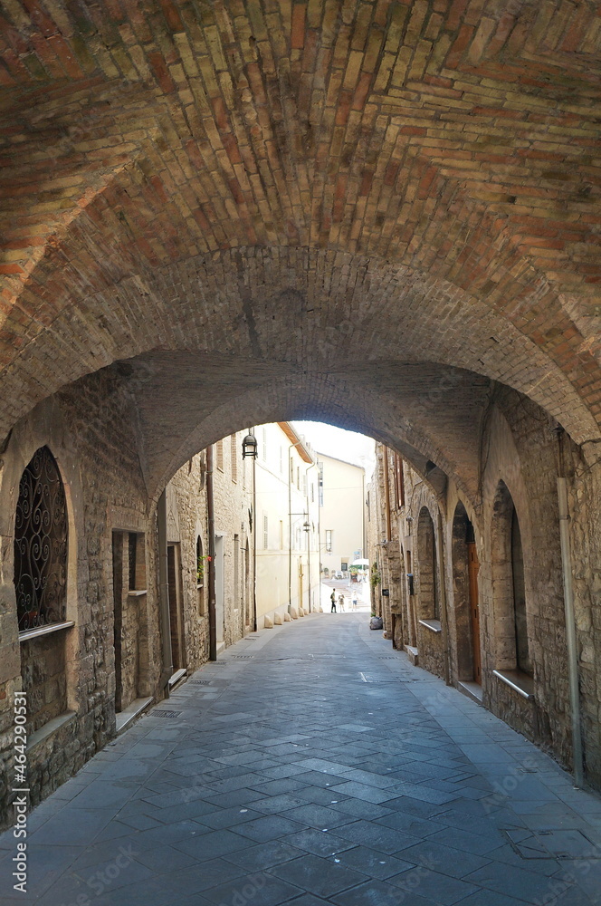 Typical alley with staircase in the medieval old town of Assisi, Italy