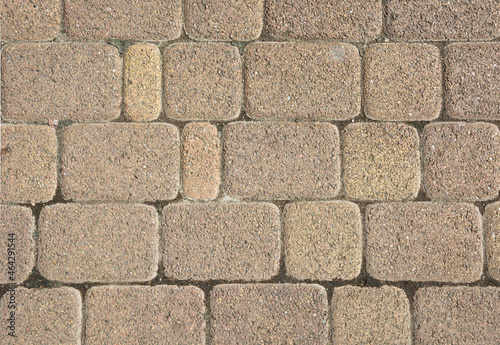 a fragment of a road made of geometrically regular stone. background for text