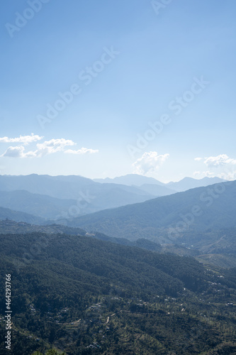 A beautiful scenic landscape of mountains of Uttarakhand with a view of Almora city. Wallpaper of uttarakhand tourism.