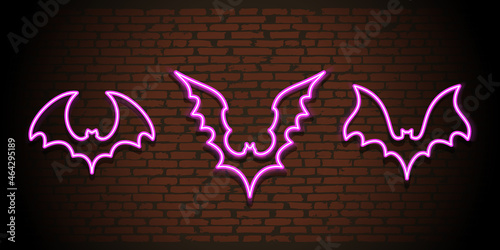 Neon bats silhouettes on brick wall background. Vector illustration