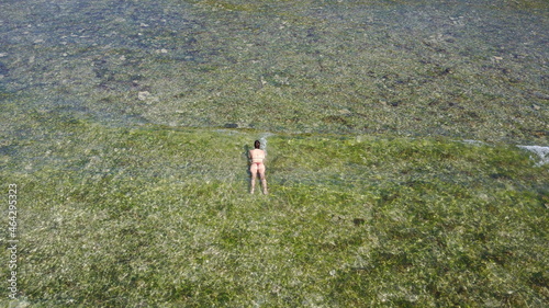 person in the ocean beach corals nature field drone aerial view summer adventure travel Bali island Indonesia girl woman bikini 