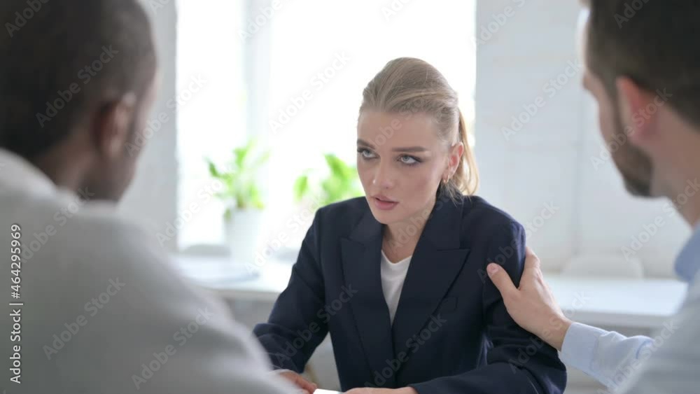 Serious Businessmen Reassuring Upset Young Businesswoman Serious Businessmen Reassuring Upset Young Businesswoman