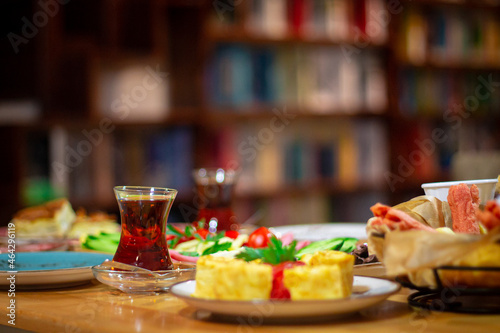 Traditional Turkish breakfast on table with books background