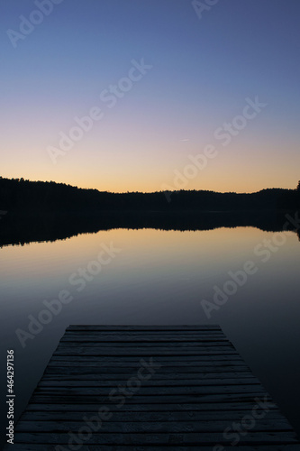 peaceful minimalistic sunset over the lake landscape blue water bridge pier