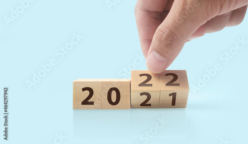 The hand puts wooden cube with the letter from the word. wooden cubes standing in hand